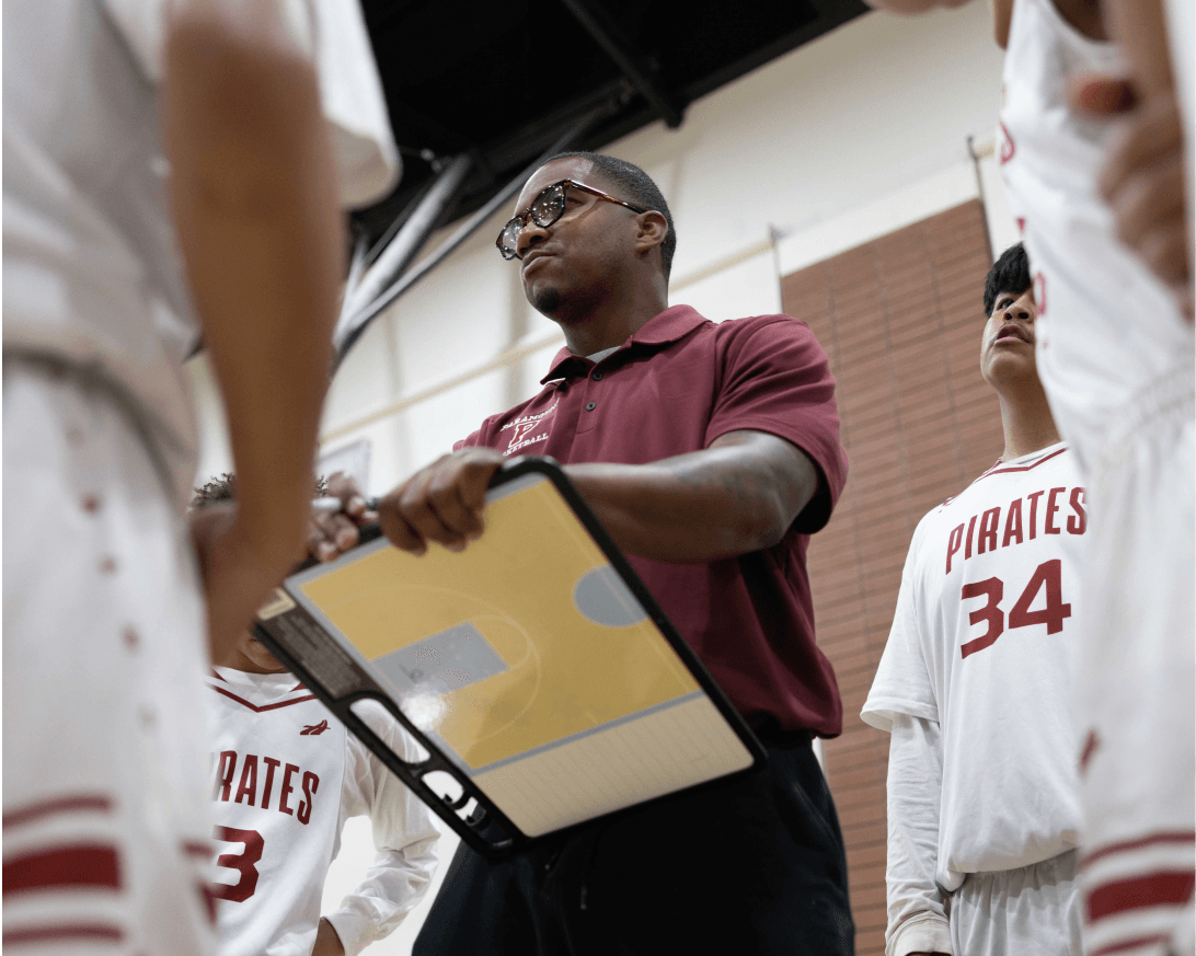 Youth basketball coach talking to players